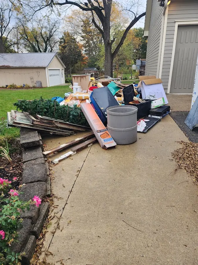 Dumpster being loaded with debris for 12 Yard Dumpster Rental in Chilton